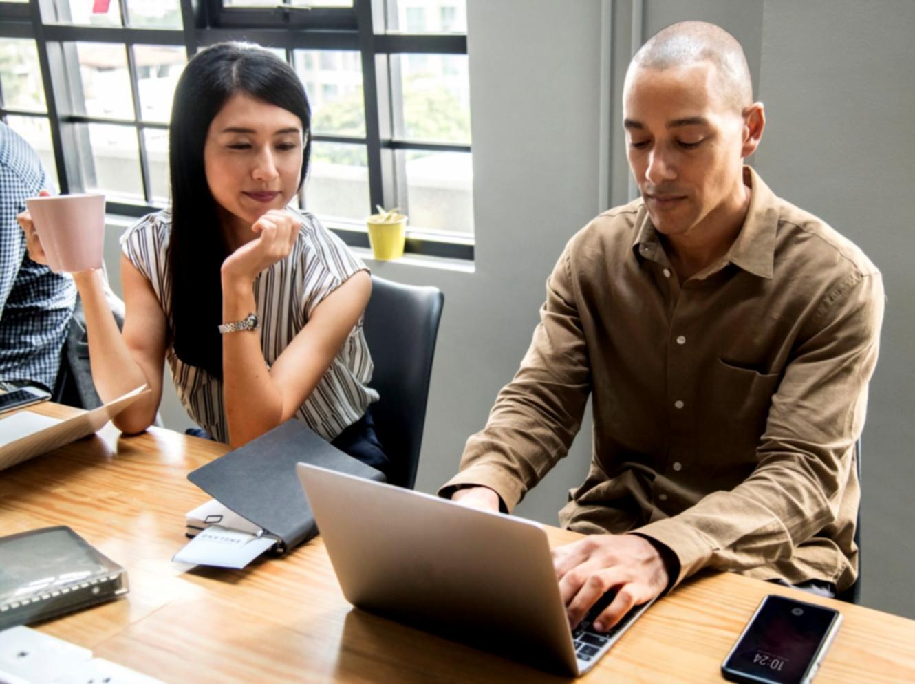 Students working on network configuration in modern computer lab